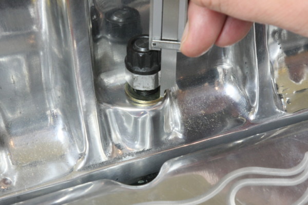 measuring height of nuts and stud assembly on a supercharger housing