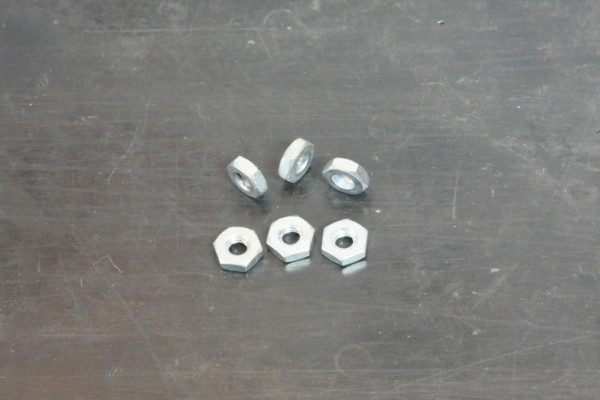 nuts and hardware on a metal table