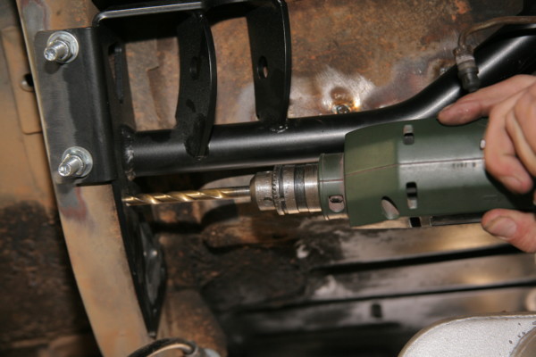 drilling holes into a mustang frame for suspension retrofit