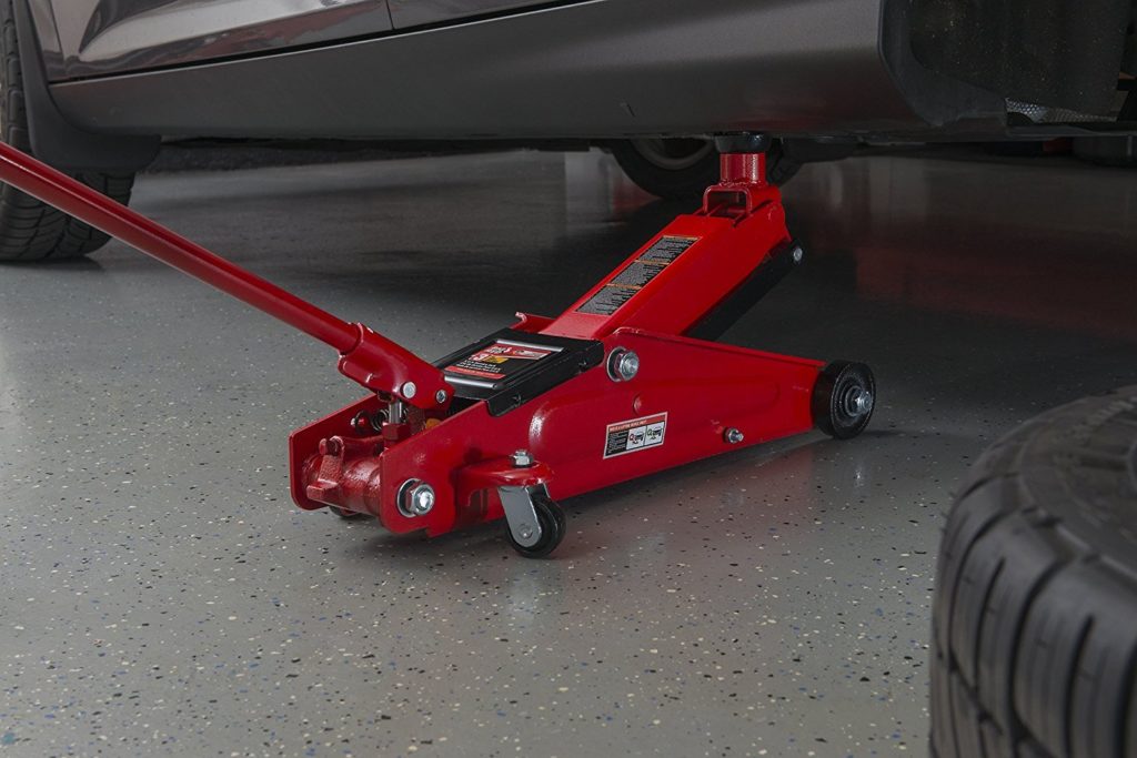 Sunex floor jack being used under a car