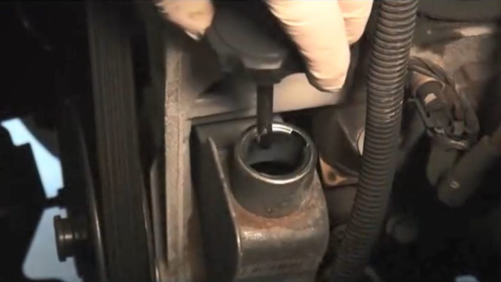 man holding dipstick for Power Steering Pump reservoir