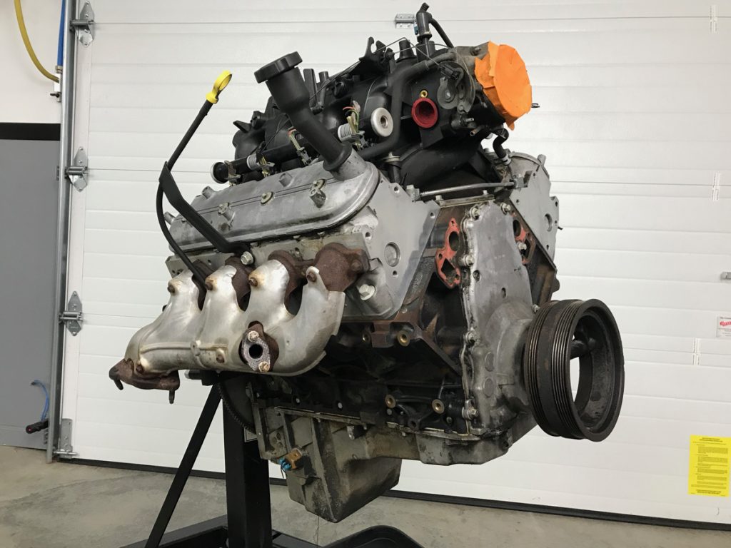 ls engine on stand in a garage