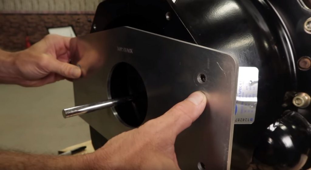 man installing index plate on quick time bellhousing