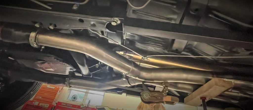 custom exhaust system under a vintage chevy nova