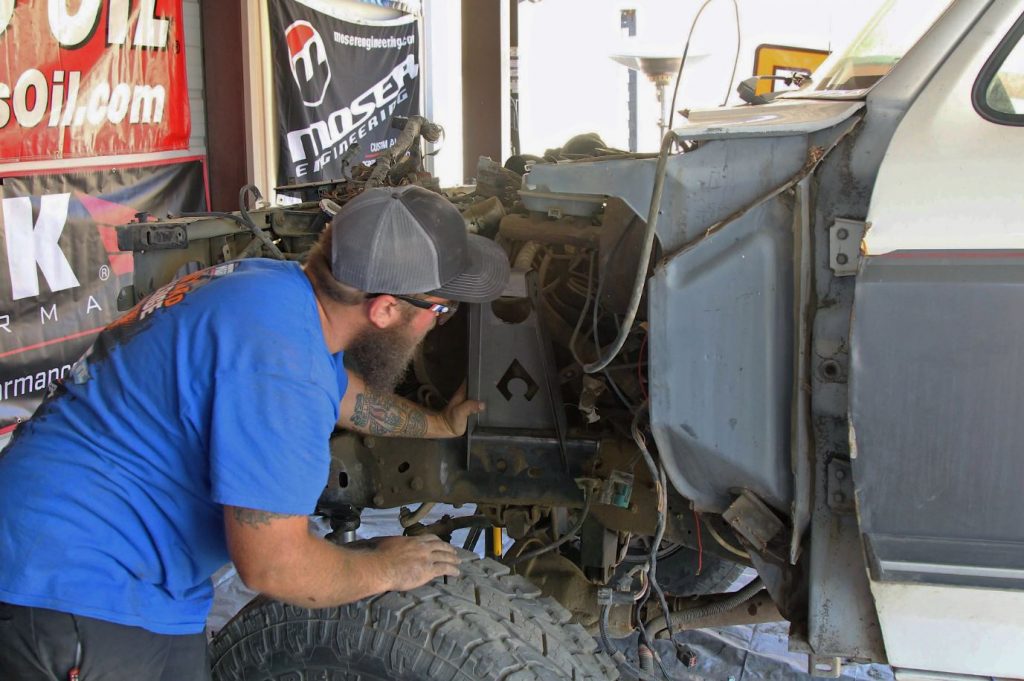 man investigating firewall of an old ford pickup truck