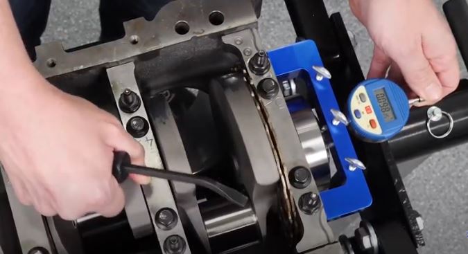 mechanic checking crankshaft endplay on an engine