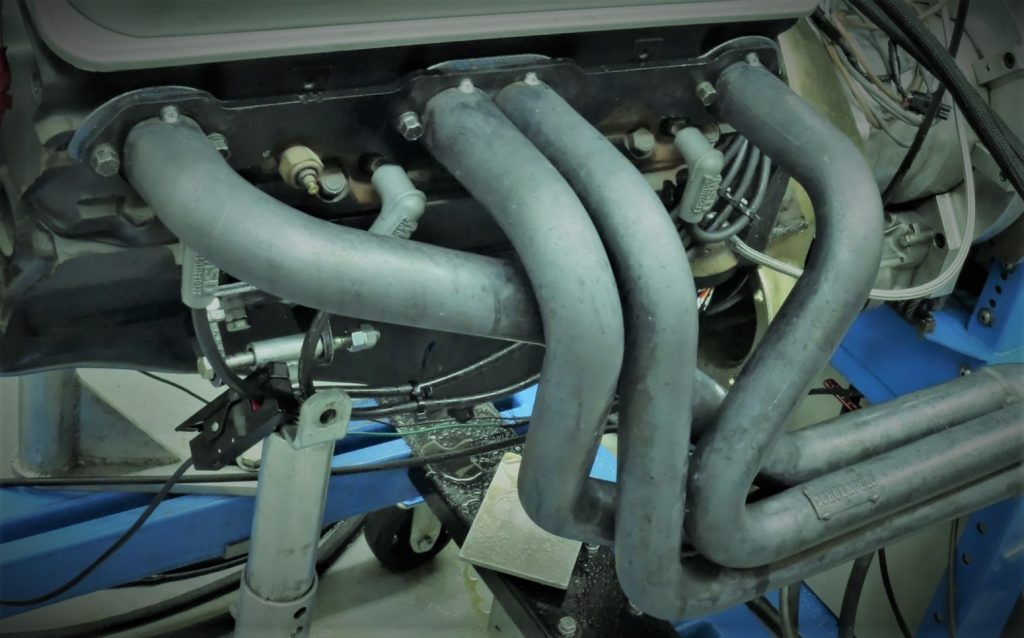 close up of headers on a chevy 305 small block v8