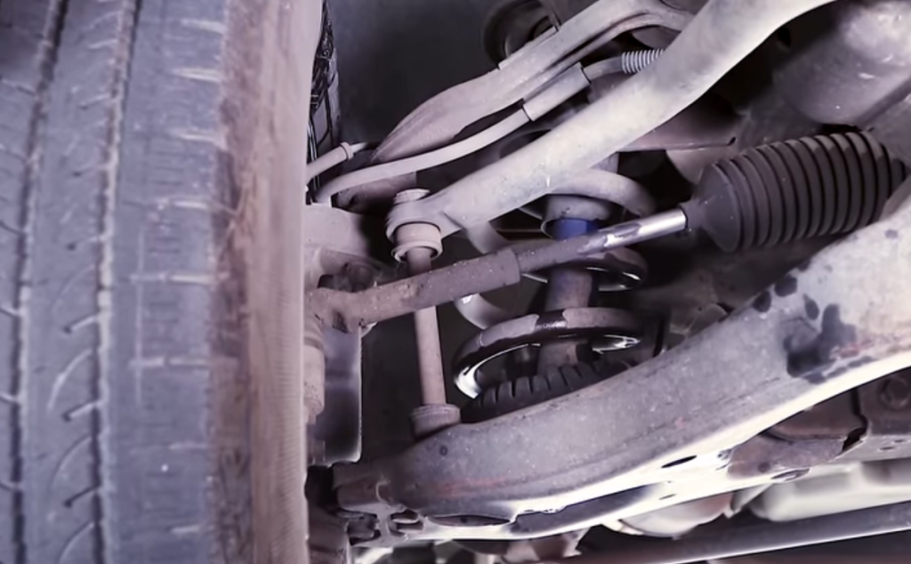 close up of blown, leaking automotive shock absorber