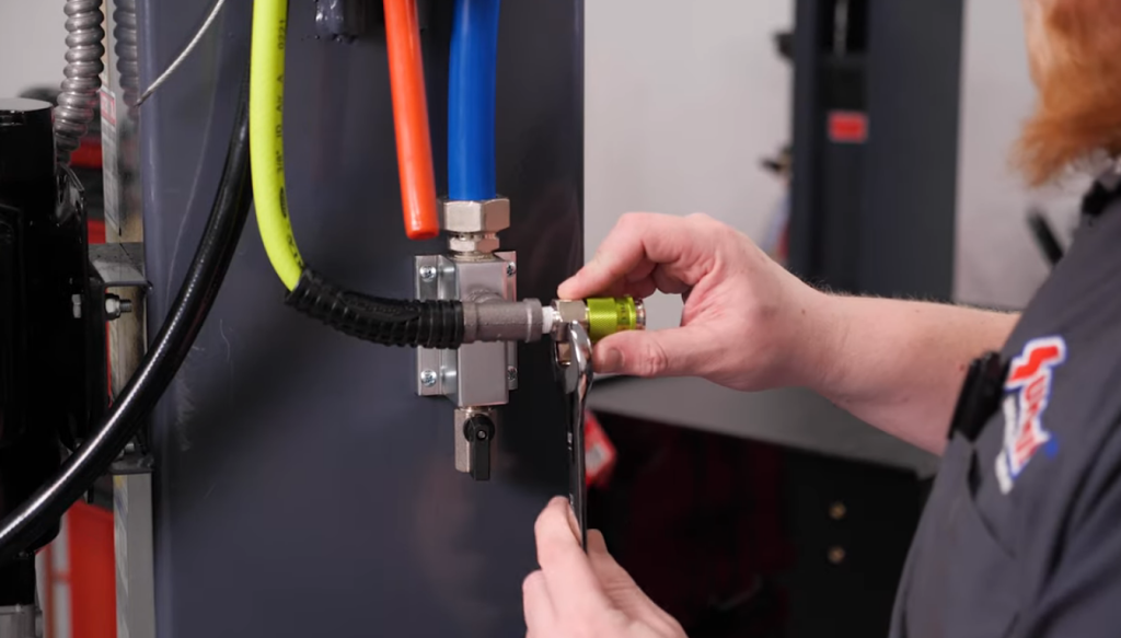 installing an air line fitting in a home garage shop