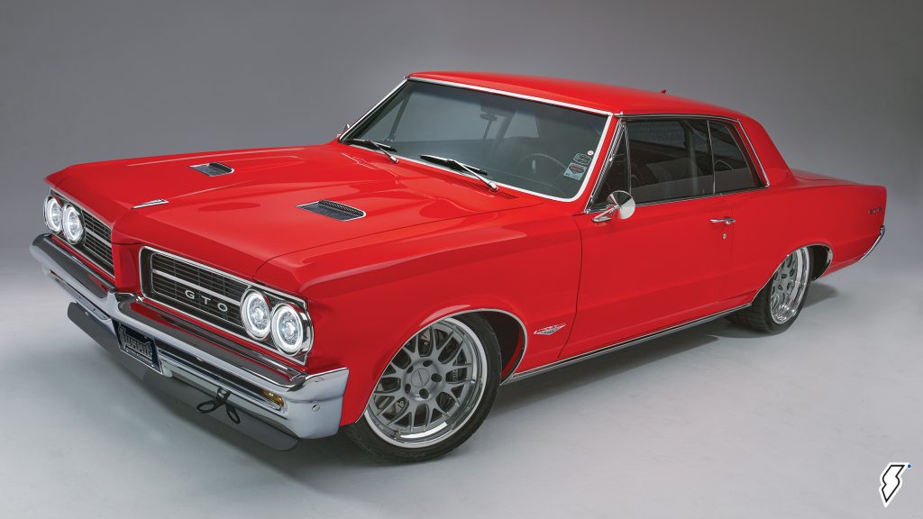 customized red 1964 pontiac gto driver side quarter shot