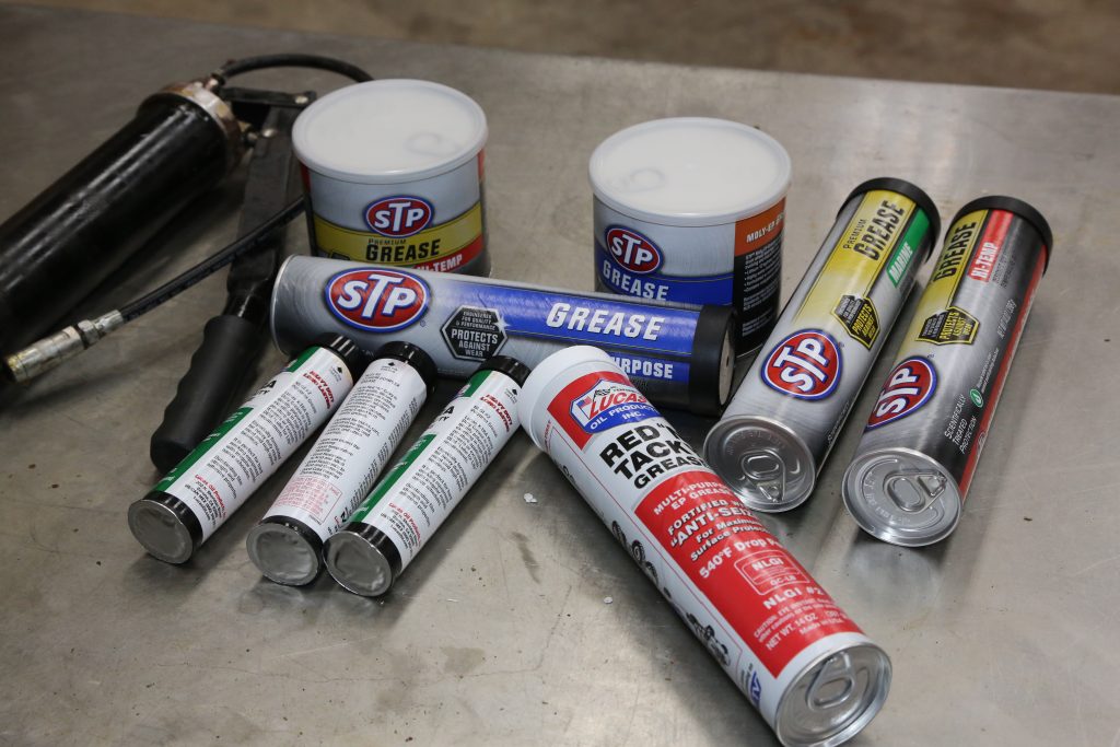 assortment of grease tubes in a garage shop