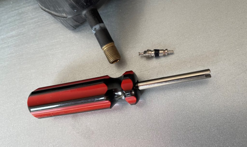 Schrader valve on table with removal tool