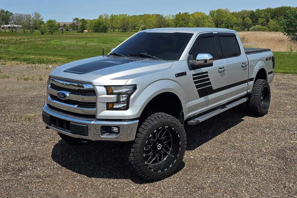 Silver 2017 Ford F150 pickup truck parked on gravel