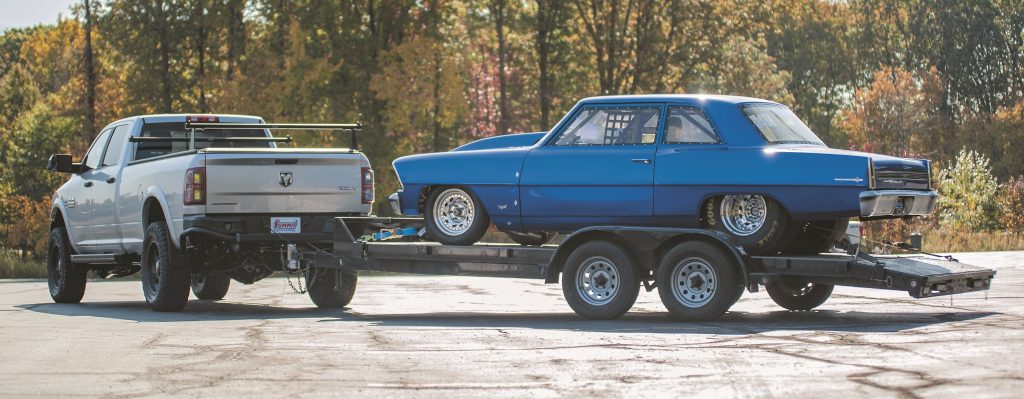 Ram 2500 truck pulling a vintage chevy 2 nova race car on a trailer