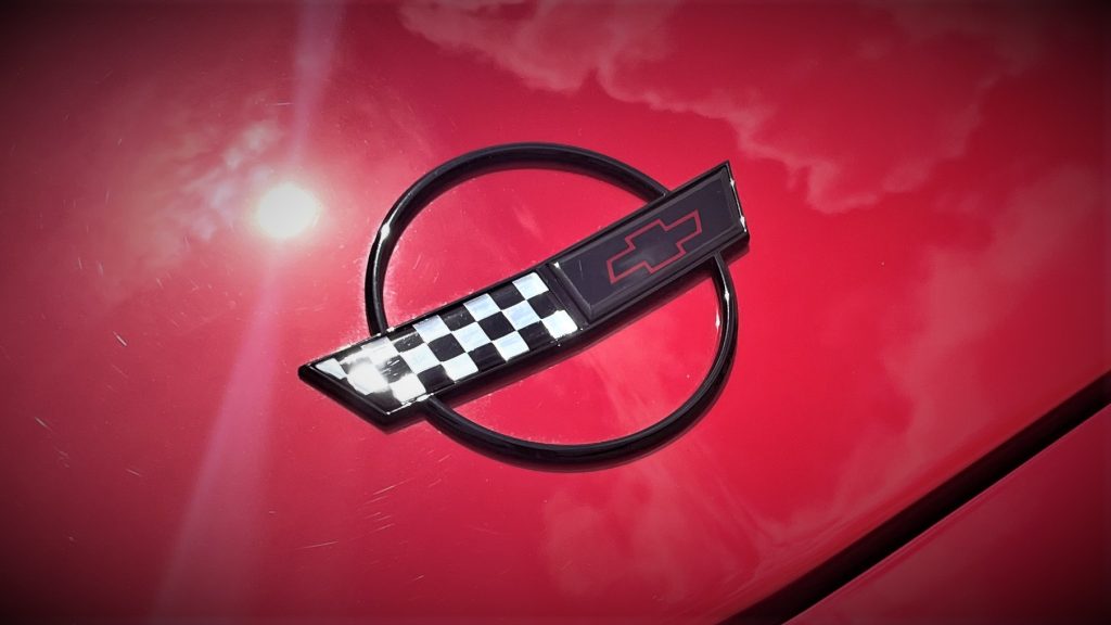 close up of c4 corvette hood emblem crossed flags