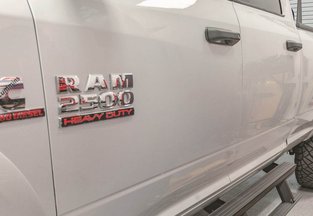 close up of a shiny silver ram truck paint job