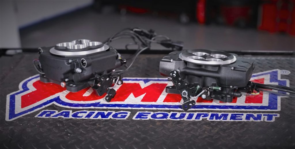 holley sniper 1 & 2 EFI throttle bodies side by side on a work bench