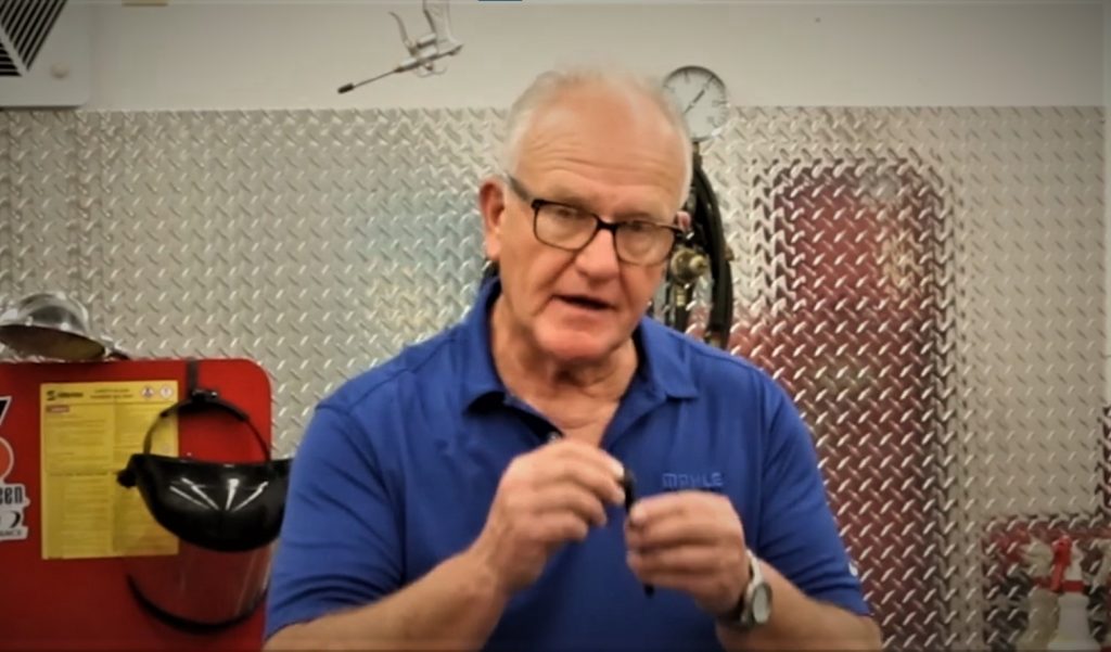 man holding a cylinder head bolt