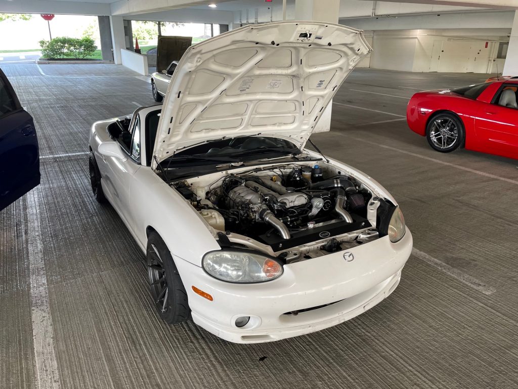 white NB mazda miata roadster with hood open