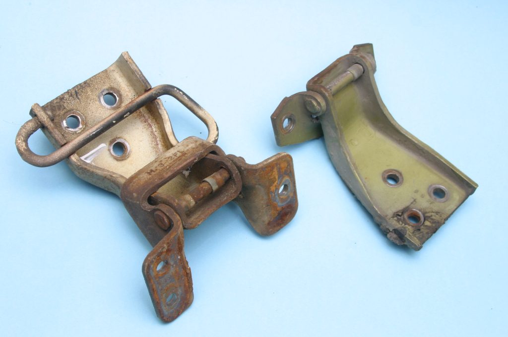 a pair of old car door hinges
