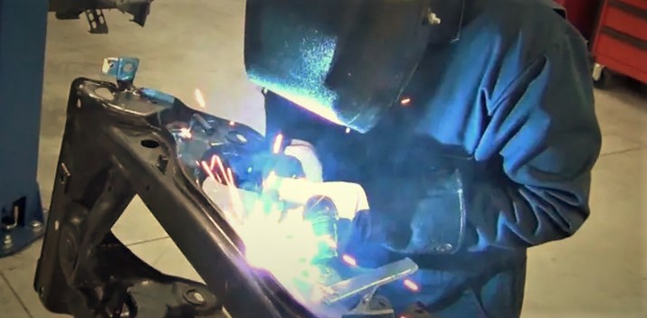 man welding on a car chassis