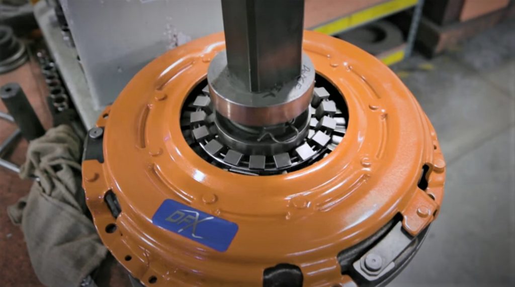 Automotive clutch being depressed on a factory tool