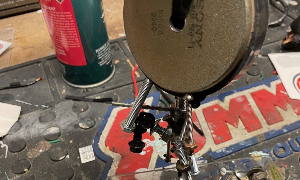 speaker magnet holding a bunch of nuts and bolts