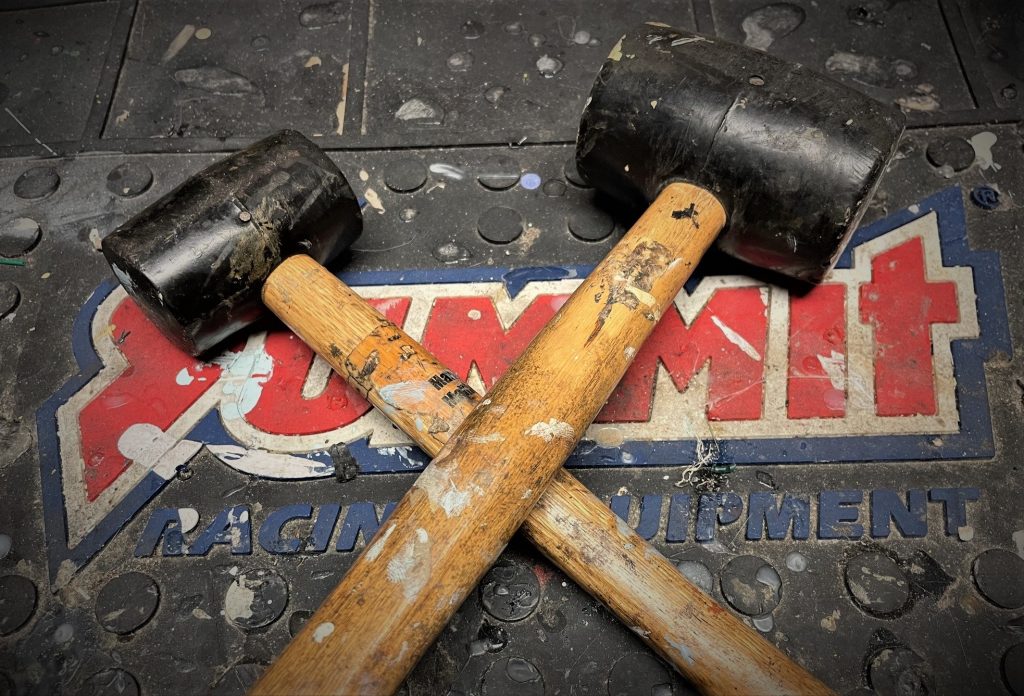 crossed rubber mallets resting on a workbench