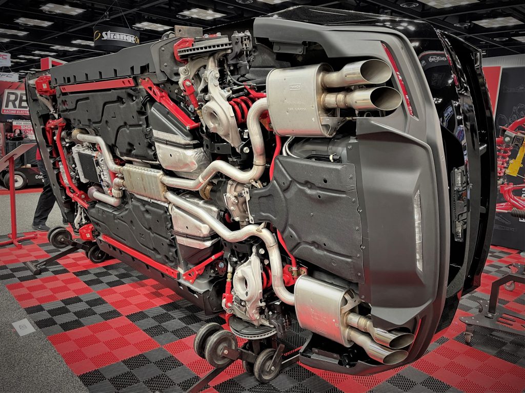2024 mustang flipped on its side to display chassis upgrade parts