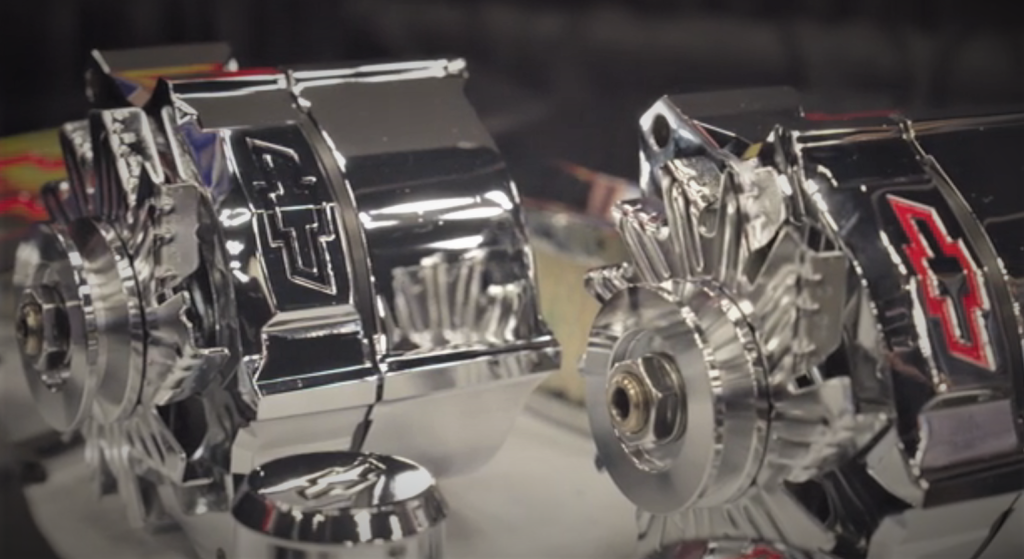 two custom alternators displayed on a table
