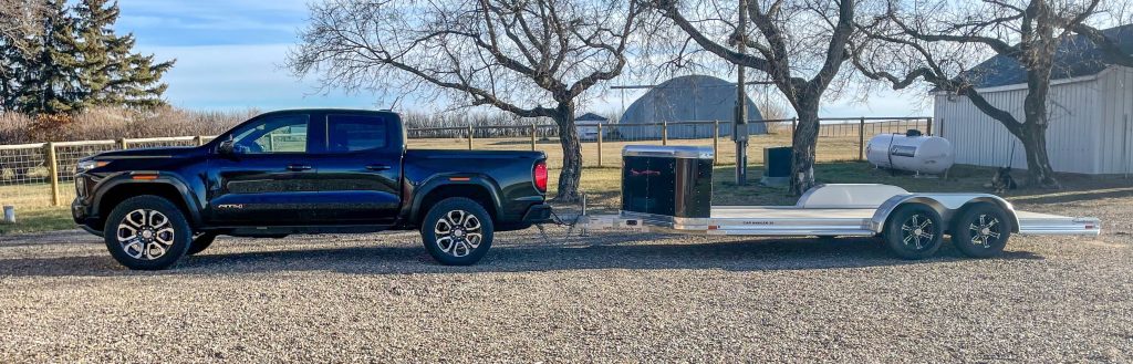 large truck and flatbed car trailer