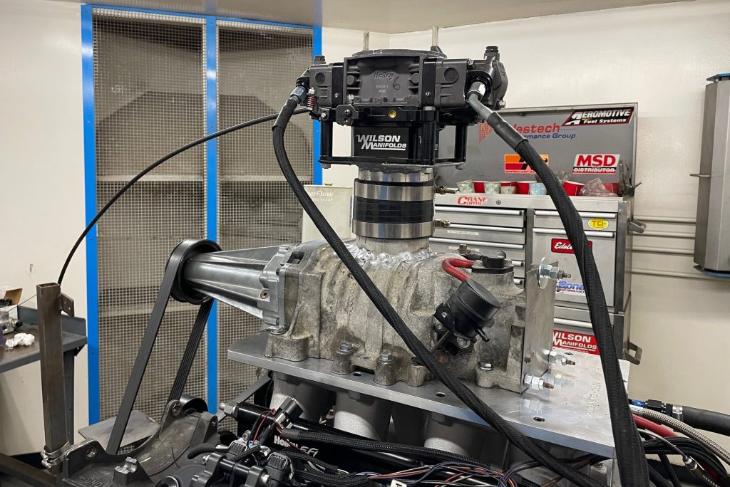 carburetor atop a blower in a dyno room