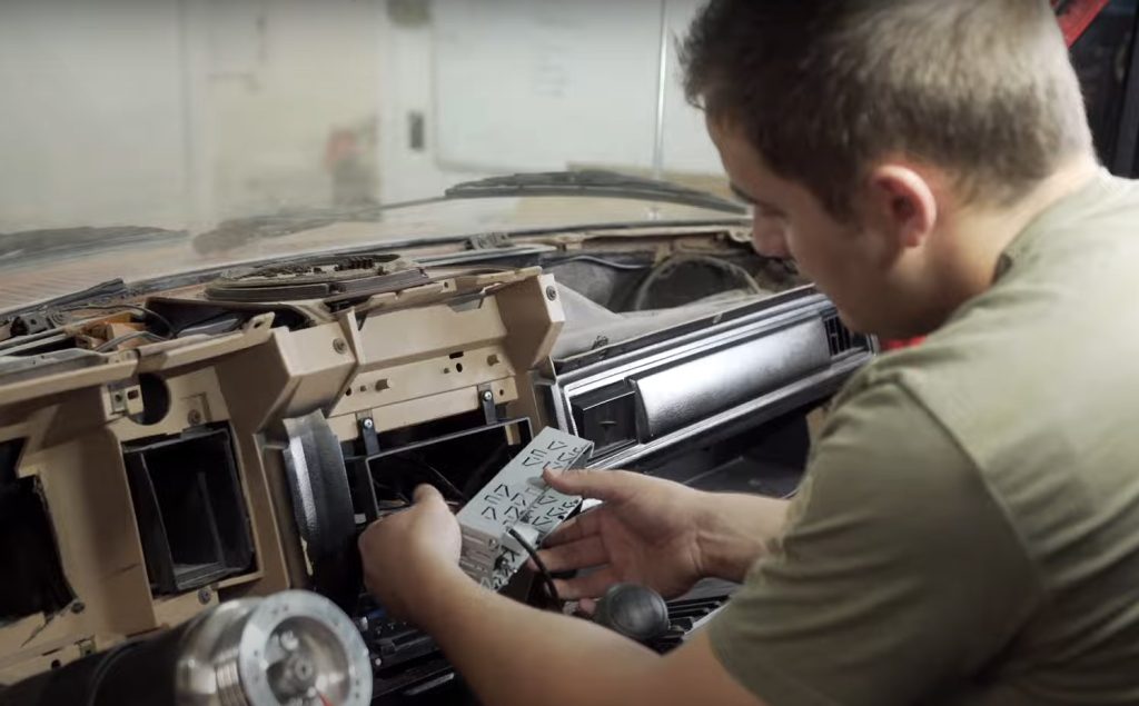 man repairing a truck dash with a retrosound DIN replacement kit