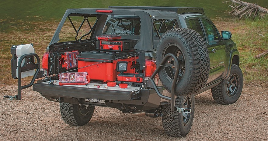 rear bed view of a toyota tacoma truck off roader parked next to a small creek