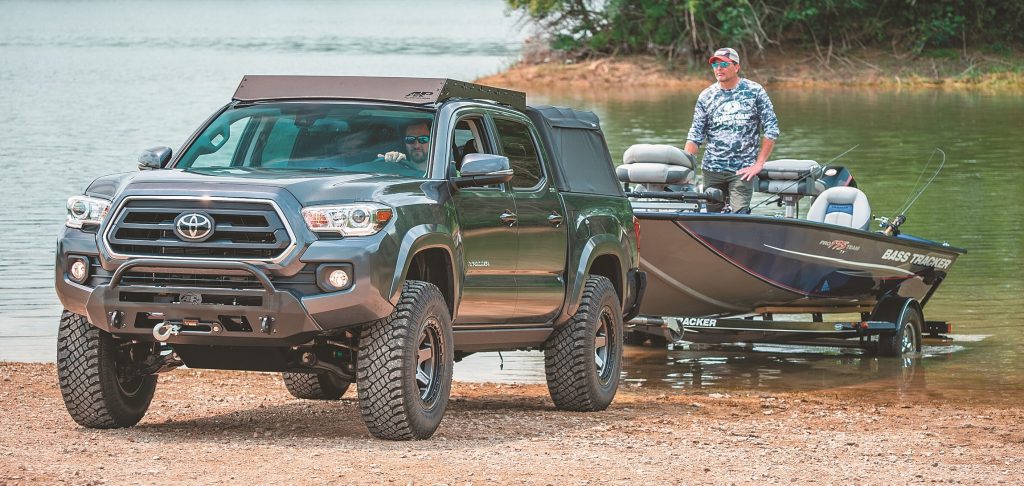 toyota tacoma launching a fishing boat on beach