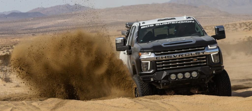 chevy silverado with bds suspension parts driving through dirt