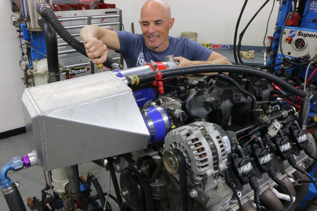 man installing intercooler shroud for dyno pull
