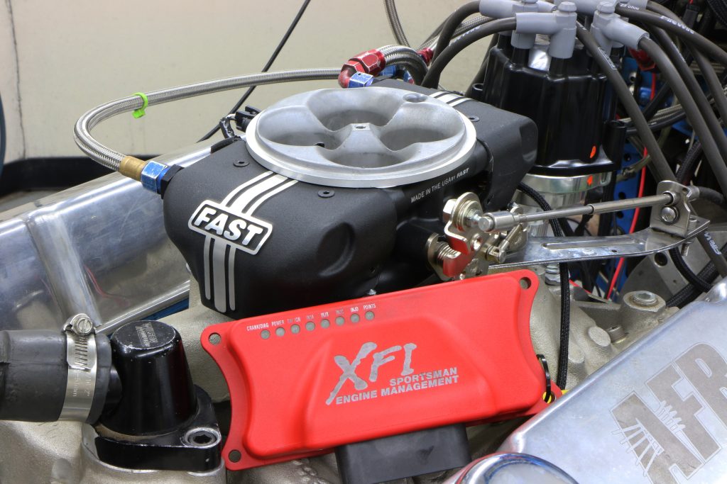 fast throttle body efi resting atop a v8 engine