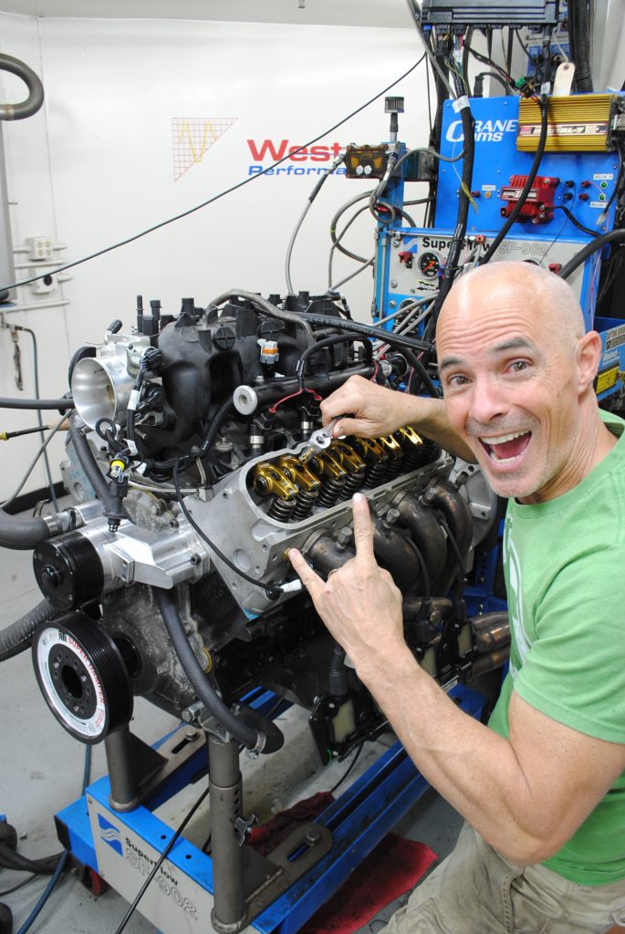 man tightening rockers on an ls engine cylinder head