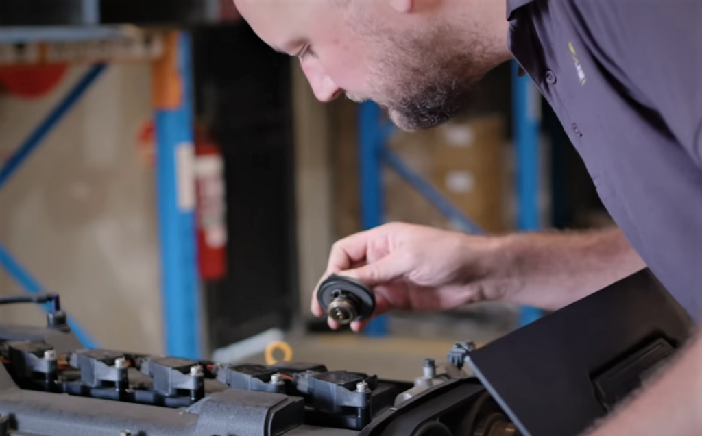 mechanic examining an engine