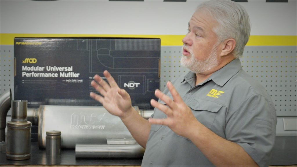 man standing near computer and muffler