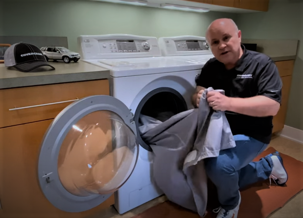 man washing a car cover
