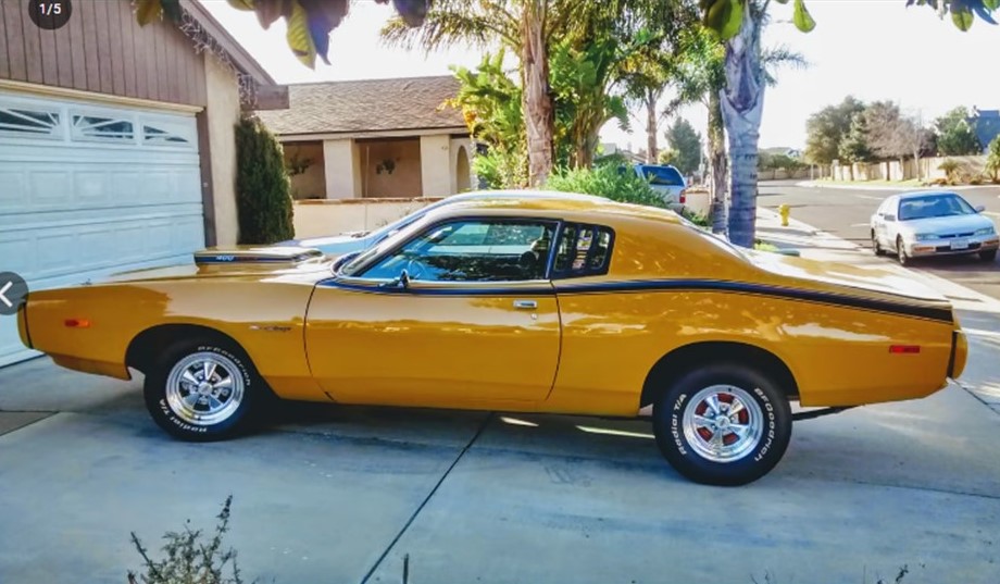 yellow 1974 Dodge Charger in driveway