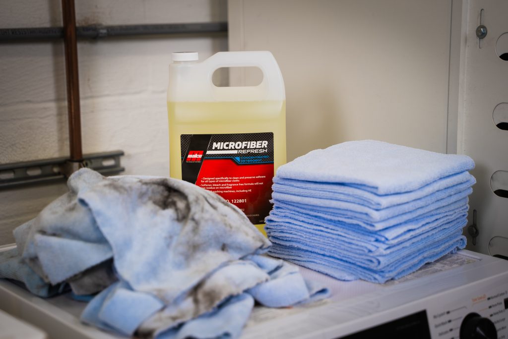 Dirty microfiber towels on a washing machine
