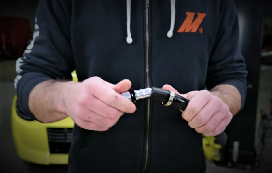 man assembling push lock hose with fitting