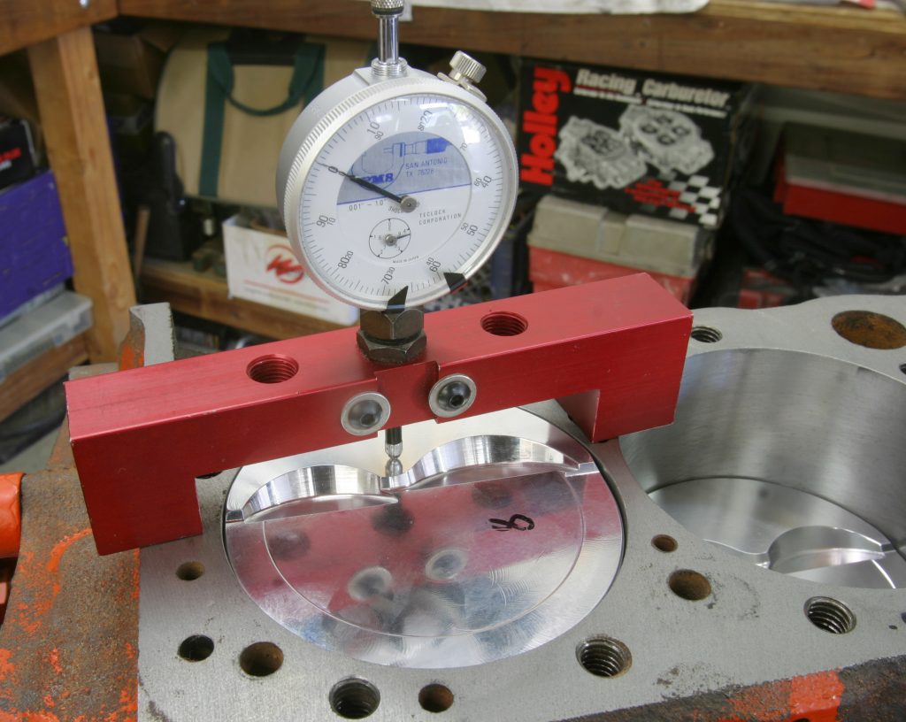 dial gauge checking for piston travel on engine block