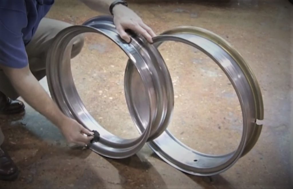 two wheel rims on a garage floor