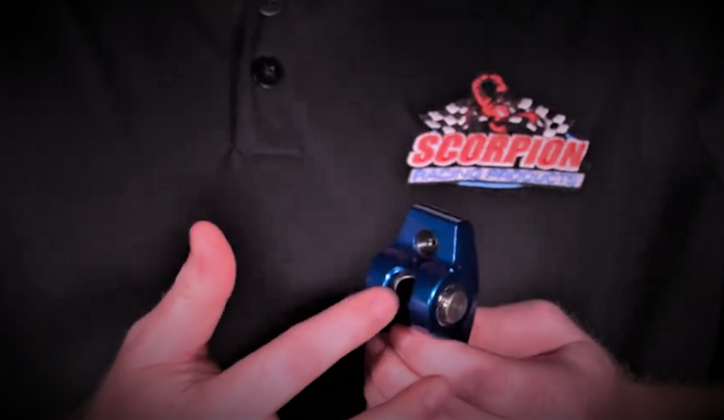 man holding an engine rocker arm