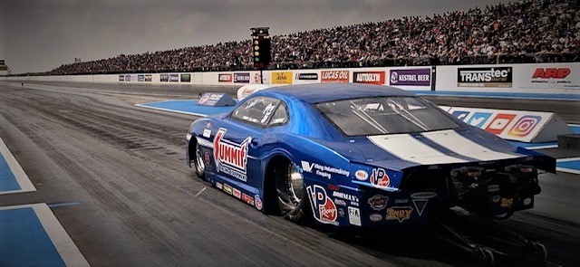 Jimmy Alund Pro Stock Camaro launching at track, rear view