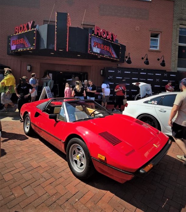 Ferrari 308 parked in front of movie theatre